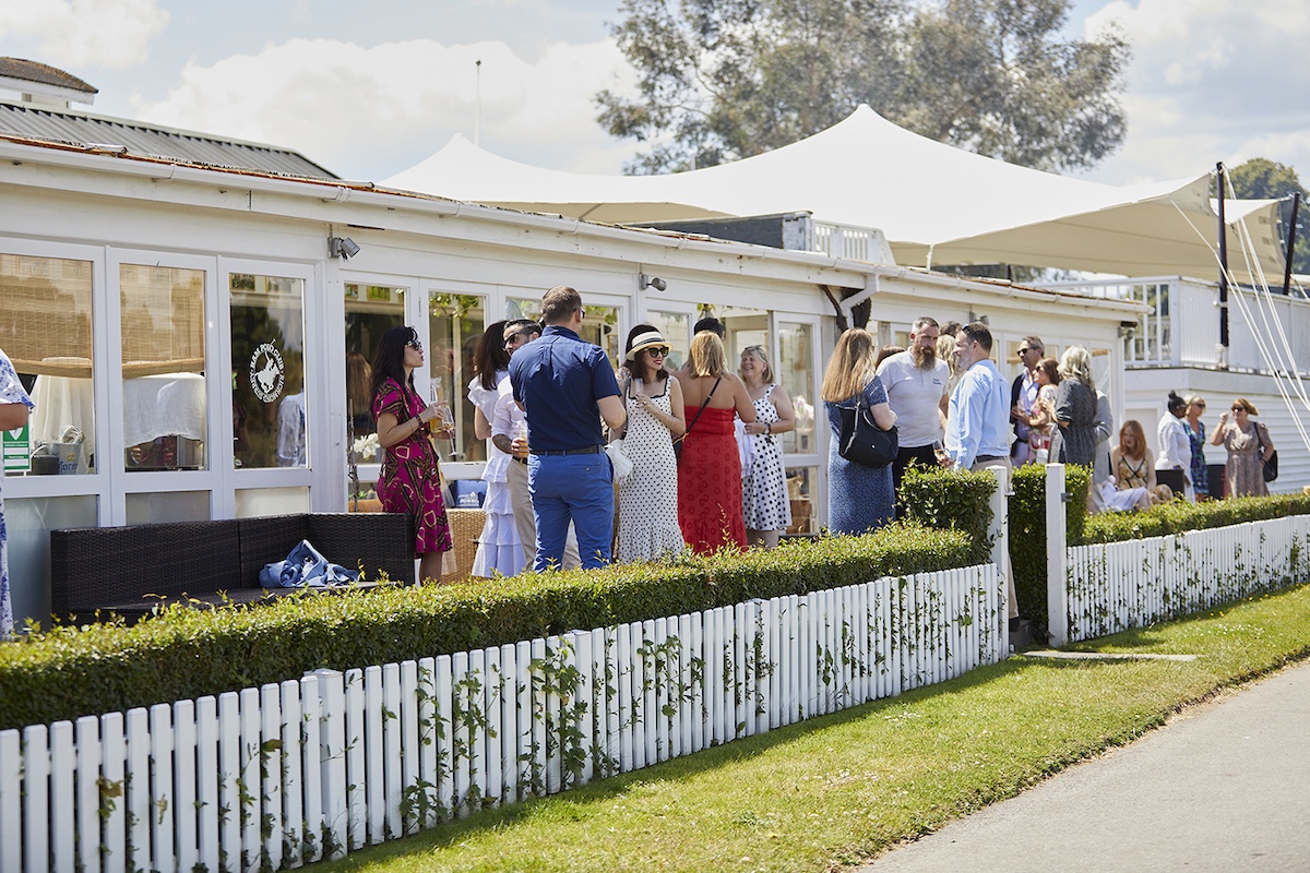 Guests enjoying drinks on the terrace at the Gaucho Polo event